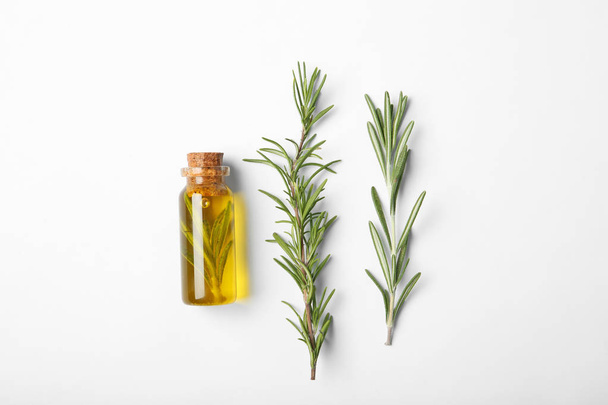 Composition with bottle of rosemary oil on white background, top view - Photo, Image