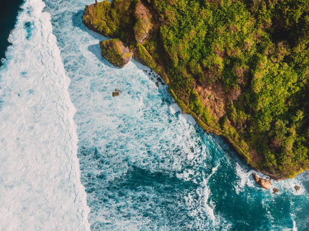 Aerial view of tropical island with cliff, rocks and ocean in Bali - 写真・画像