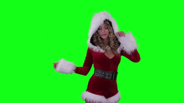 Beautiful blonde woman dancing in cute Santa Claus costume on green background - Video