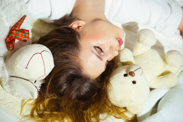Young tender girl sleeping with her toys - Photo, Image