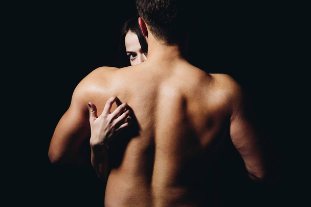 Loving his body. Woman hand touch man torso, rear view. Couple in love. He is absolutely mine. Back disease and treatment. Massage for back health. Sex games - Photo, image