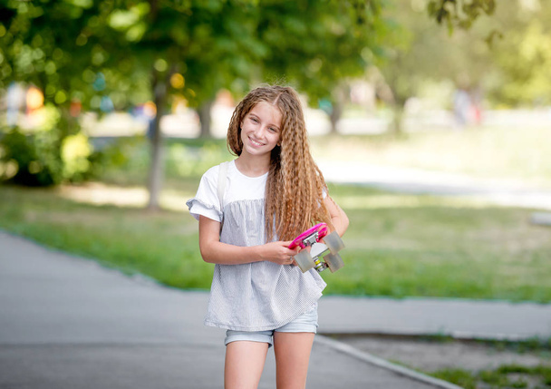 teenage girl holding her pink board - Фото, изображение