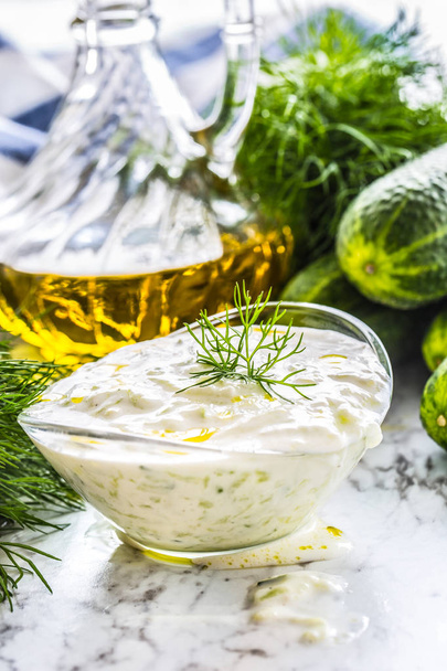 Greek dip sauce or dressing tzatziki prepared  with grated cucumber sour cream yogurt olive oil and fresh dill. - Photo, image