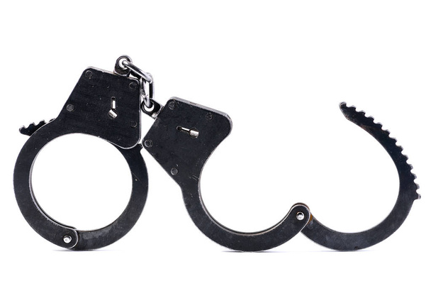 Disclosed black metal handcuffs isolated on white - Foto, immagini