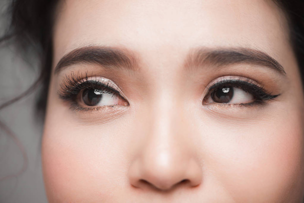 Closeup shot of beautiful asian woman eye with long eyelashes - Фото, изображение