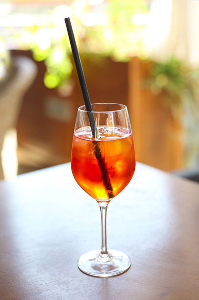 Cocktail glass on wooden table outdoor - Valokuva, kuva