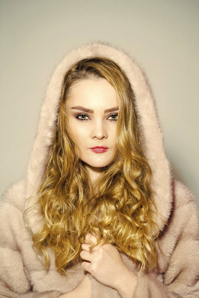 Beauty fashion model portrait. Woman in mink fur coat and hood on head - Photo, Image