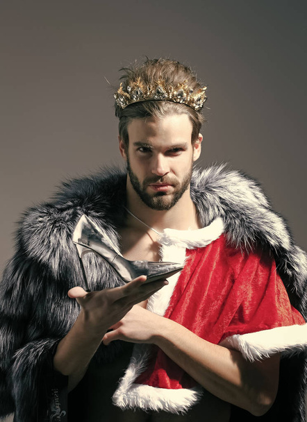 Beauty fashion model portrait. Christmas guy in santa fur coat in crown. - Foto, imagen