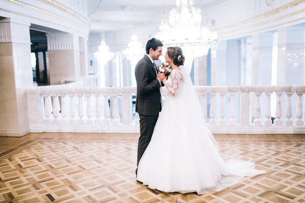 happy young  beautiful  couple of newlyweds holding hands - Фото, изображение