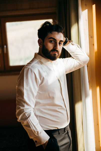 young handsome  groom posing by window  - Photo, image