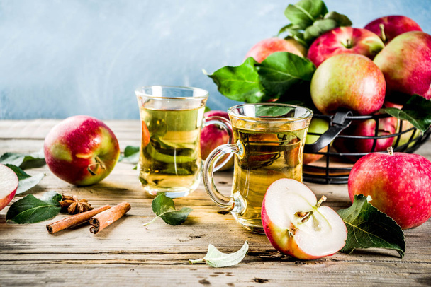 Kotitekoinen omenasiideri kanelilla ja anismausteilla, tuoreet omenat puisilla maalaismaisilla taustakopioilla
 - Valokuva, kuva