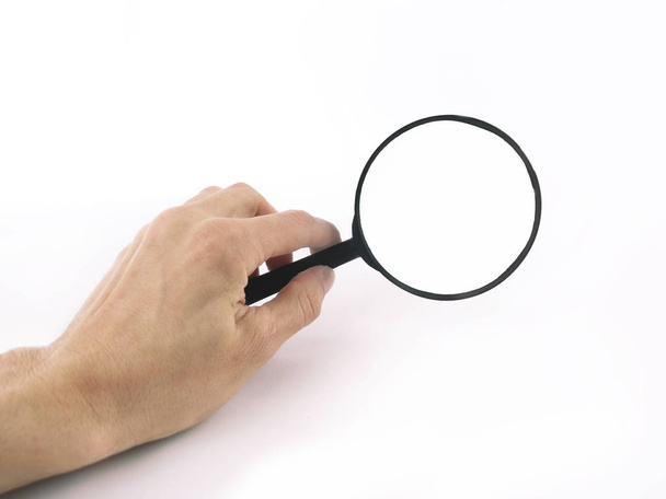 close up. magnifying glass in hand businessman.photo with copy s - Foto, Imagem