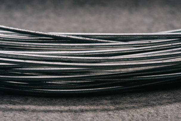 selective focus of grey wires on tabletop - 写真・画像