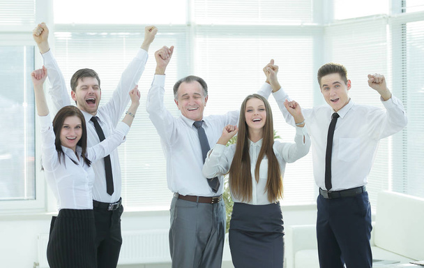 group of happy young people in formal wear celebrating, gesturing, keeping arms raised - Fotografie, Obrázek
