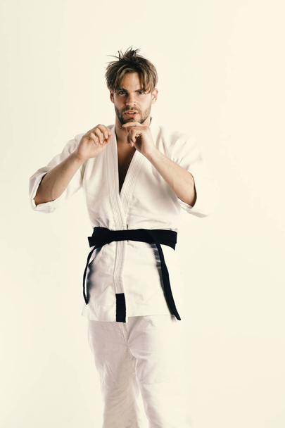 Karate man in a kimono in fighting stance - Φωτογραφία, εικόνα