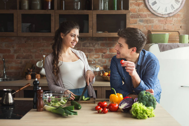 Happy couple cooking healthy food together - Photo, Image