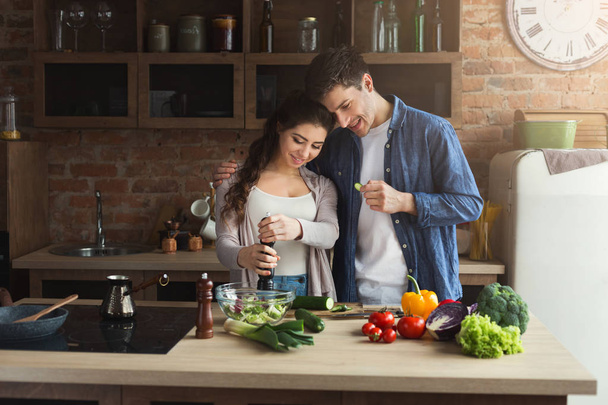 Happy couple cooking healthy food together - 写真・画像