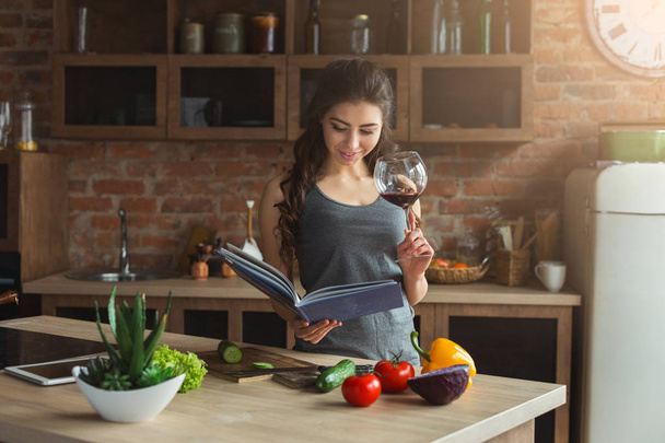 Happy woman preparing healthy food in kitchen - Photo, Image