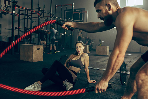 Men with battle rope battle ropes exercise in the fitness gym. - Foto, Imagem