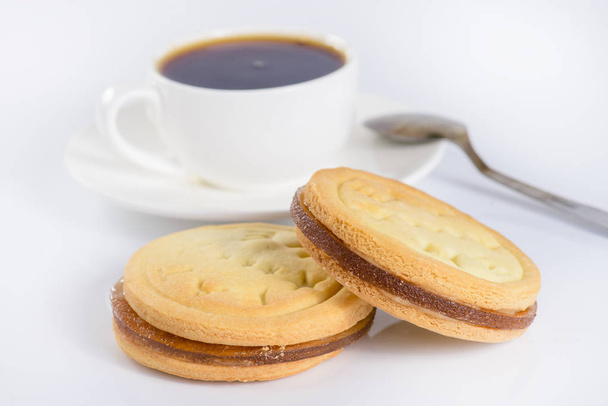 French sweet cookies and cup of coffee on light background - Foto, Imagem