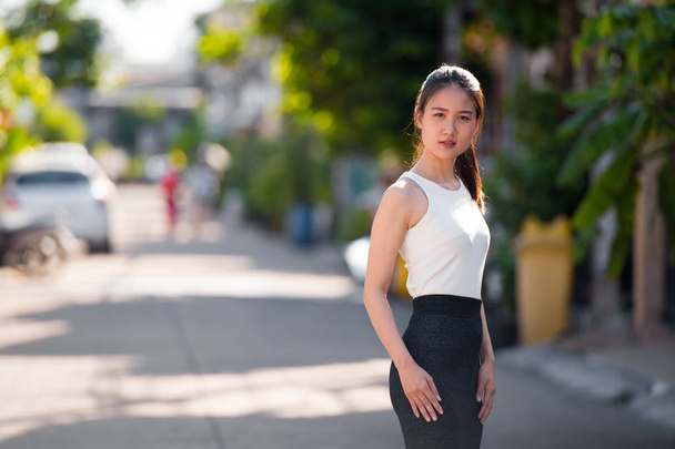 Young beautiful Asian businesswoman outdoors - 写真・画像