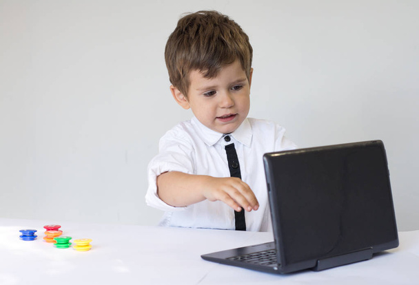 Child with notebook. Young business boy in office. - Photo, Image