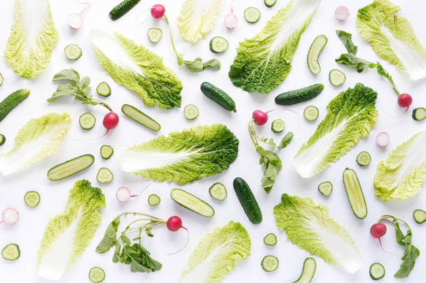 Seamless pattern made of chinese cabbage, radishes, cucumbers and onions isolated on white background - 写真・画像