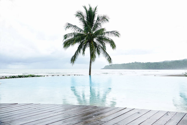   View of an empty swimming pool looking towards the ocean in a resort in Panama                              - Foto, Imagen