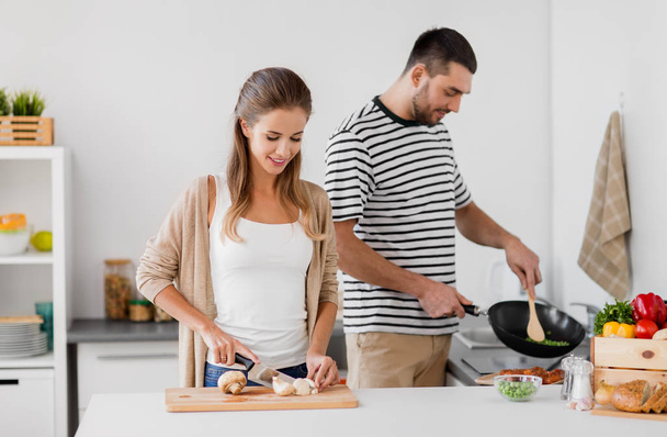 couple cooking food at home kitchen - Valokuva, kuva