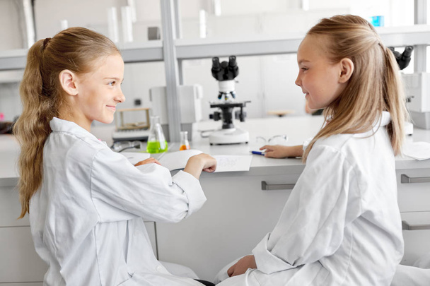 girls with notebook at laboratory - Foto, Imagen