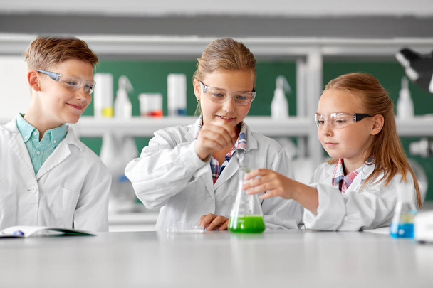 kids with test tube studying chemistry at school - Foto, Imagen