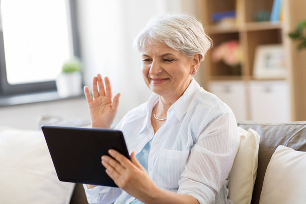 senior woman having video chat on tablet pc - Foto, immagini