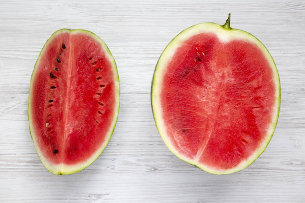 Fresh cut watermelon on a white wooden surface, top view. Closeup. - Photo, Image