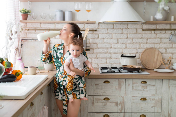 warm and loving relationship between mother and child in the kitchen - Photo, image