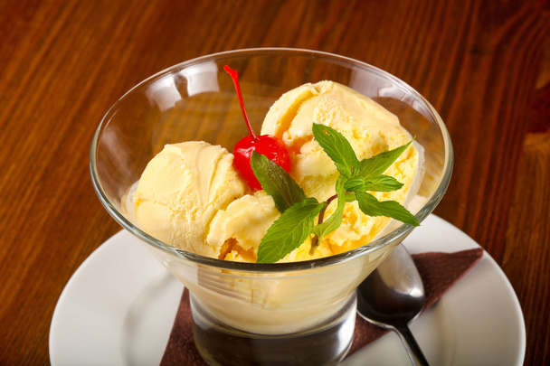 Vanilla ice-cream with mint and cherry - 写真・画像