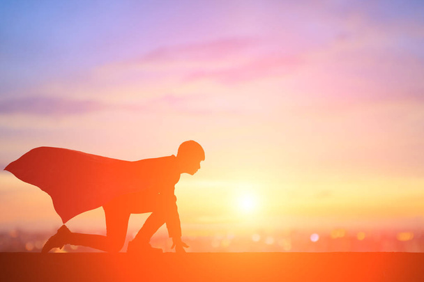 silhouette of super businessman running at sunset - Фото, изображение
