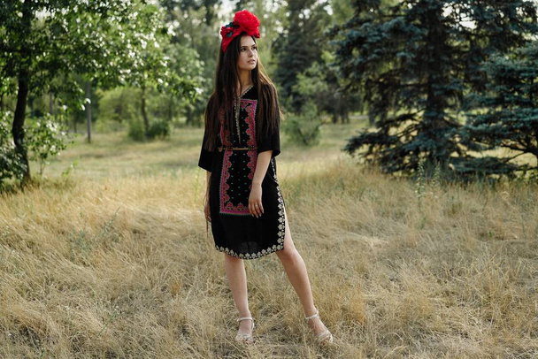 attractive young woman in beautiful headdress posing outdoors  - Zdjęcie, obraz