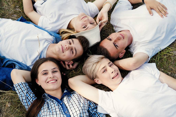 Group of young happy friends spending time outdoors  - Photo, Image