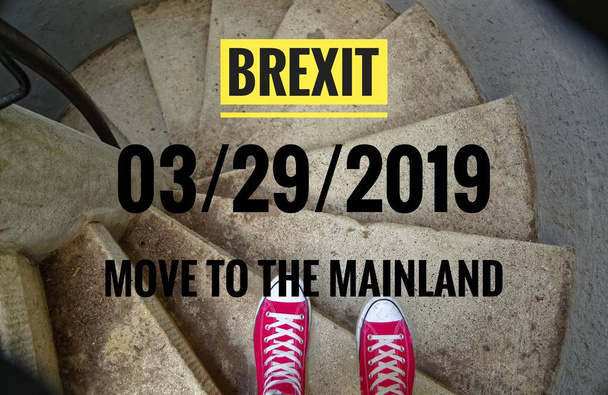 Red sneakers on spiral staircase when going downhill with inscription in english Brexit and 03/29/2019 and move to the mainland, in german 29.03.2019 und zieh aufs Festland, symbolizing the withdrawal of Great Britain from the EU - Photo, Image