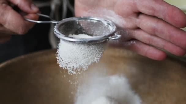 Female hands sifting flour by bowl. - Filmati, video