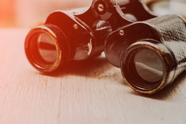 Vintage binoculars on a white wooden background - Foto, Imagem