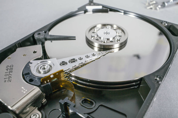Hard disk drive platter. Open hdd hard disk. Data recovery from damaged media. Disk head above the plates - Photo, Image