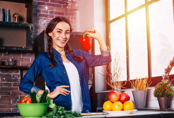Young Woman in the kitchen. Healthy Food. Diet. Dieting Concept. Healthy Lifestyle. Cooking At Home. Prepare Food. Very Beautiful cheerful young brunette woman holding vegetables and smiling. - Photo, Image