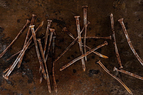flat lay with vintage nails arranged on sharped rusty surface - Photo, Image