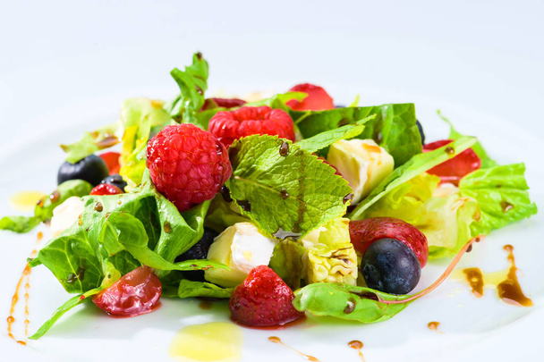Appetizing fresh vegetarian salad with different berries, tomato - Foto, Imagen
