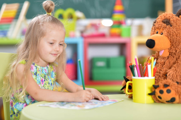  cute little girl drawing at table - Foto, Imagen