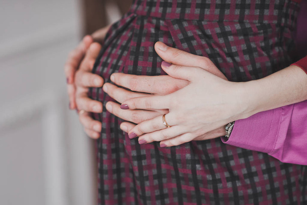 A man stroking the huge belly of a pregnant girl. - Fotografie, Obrázek