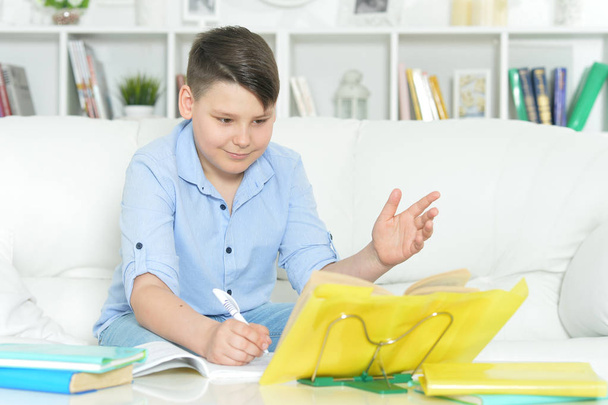  boy doing homework at home. Education  - Foto, afbeelding