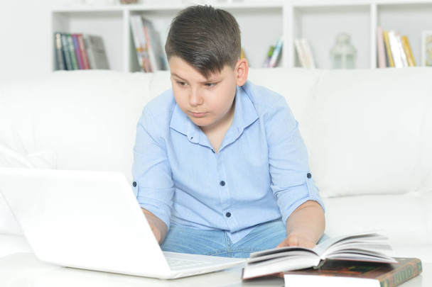  boy doing homework with laptop at home. Education concept - Φωτογραφία, εικόνα