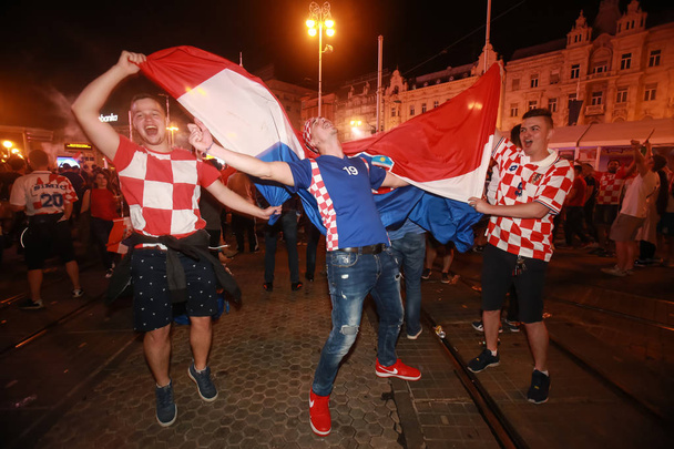 ZAGREB, CROATIA - JULY 11, 2018 : Croatian football fans celebrating victory of 2:1 Croatia vs England in semifinales Fifa World cup 2018 on Ban Jelacic Square in Zagreb, Croatia. - Valokuva, kuva